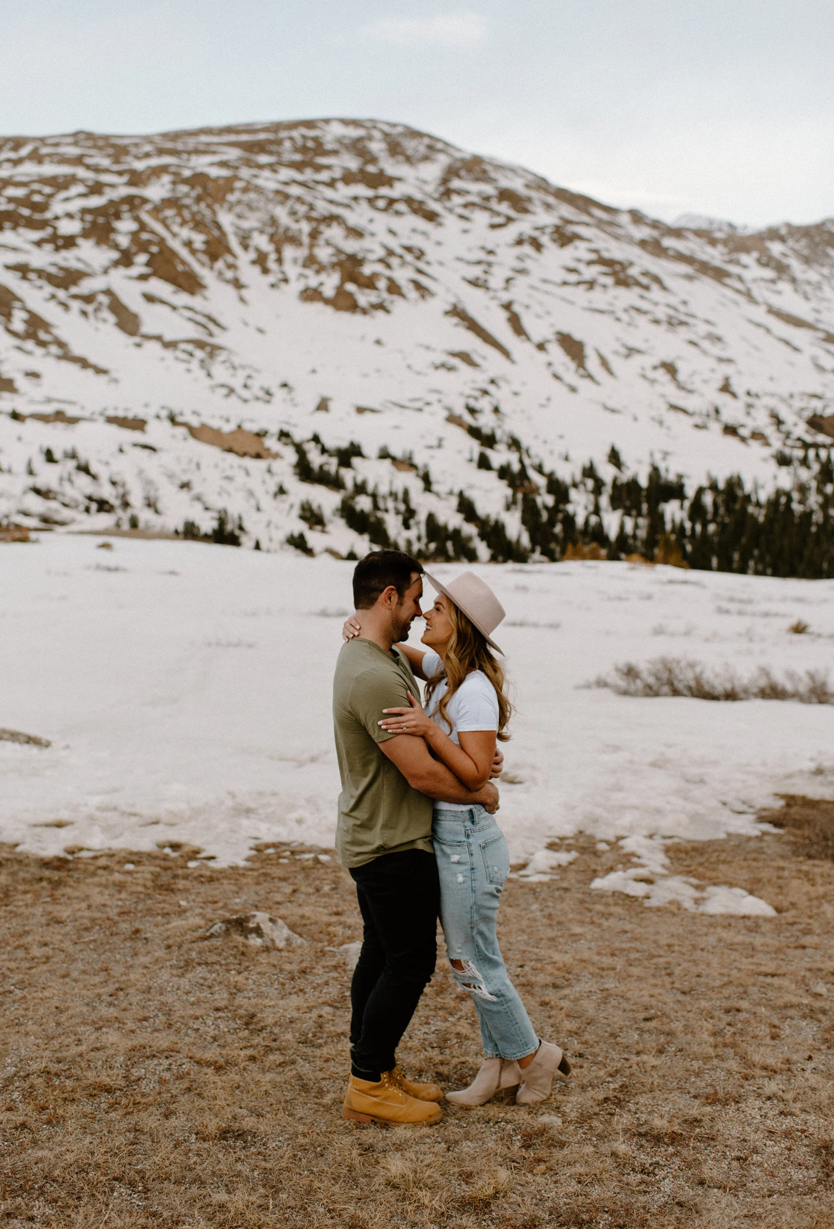  Loveland Pass engagement session in Colorado. Colorado wedding and elopement photographer, Alyssa Carpenter. Colorado wedding photography. Colorado adventure engagement session photographer. Mountain engagement session. Casual engagement session outfit ideas. Loveland Pass elopement. Snowy mountain engagement photos in Colorado.  