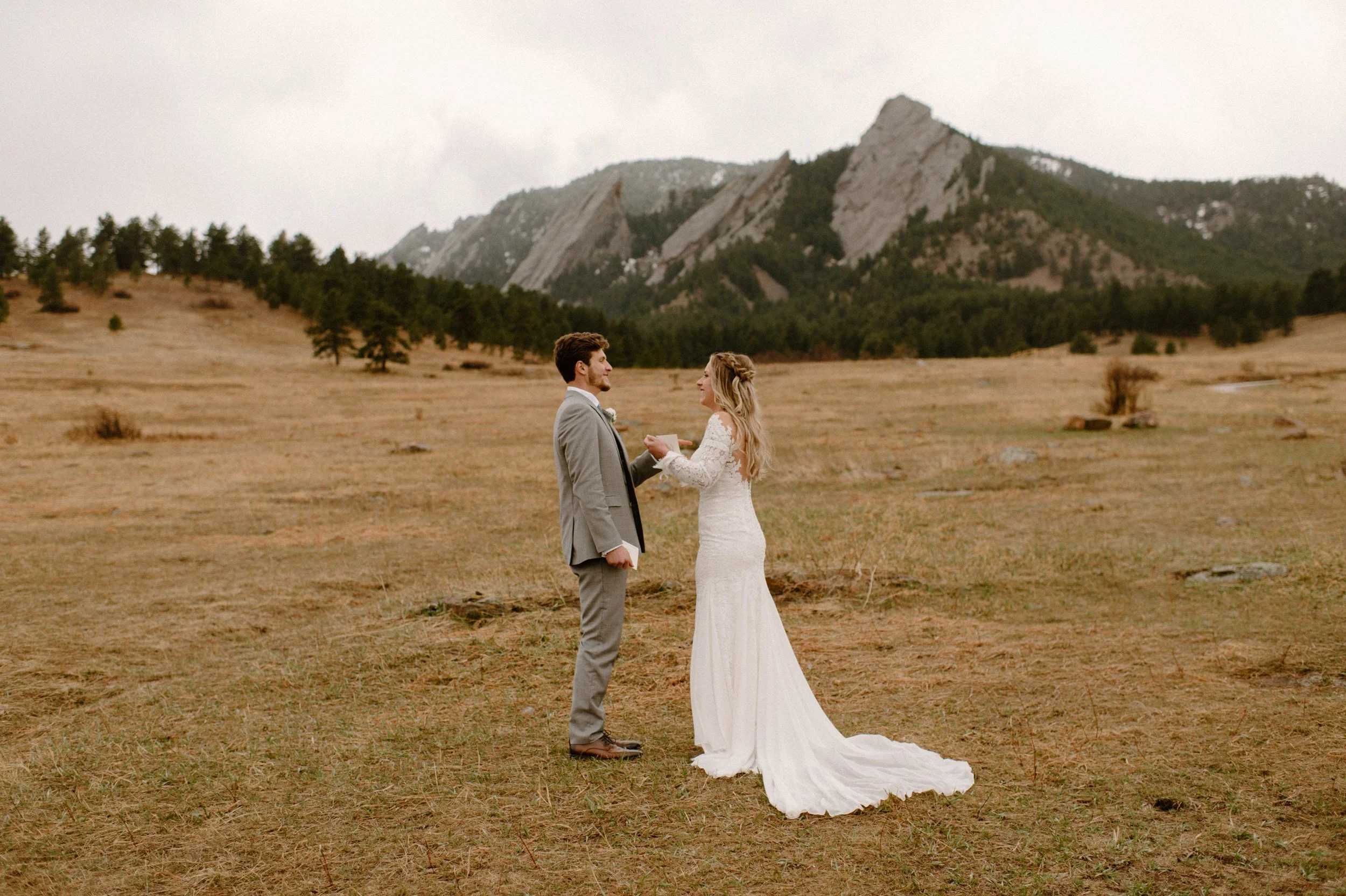  Colorado elopement in Boulder, Colorado at the Flatirons near  Chautauqua Park. Bride and groom exchanging wedding vows. Bride and groom exchanging rings. Colorado wedding photographer.  