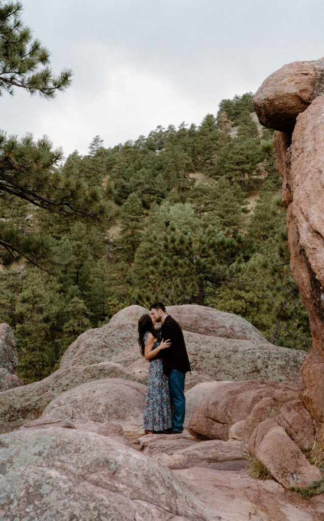Couple kissing on a hike in Boulder, CO during engagement session