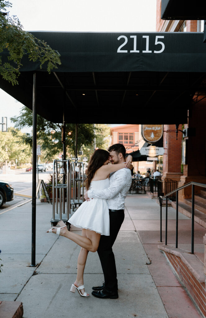 Couple hugging on Pearl Street during engagement session 