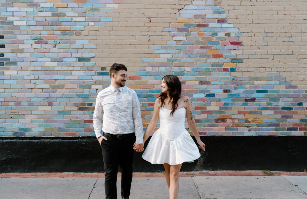 Couple walking on Pearl Street during engagement session 