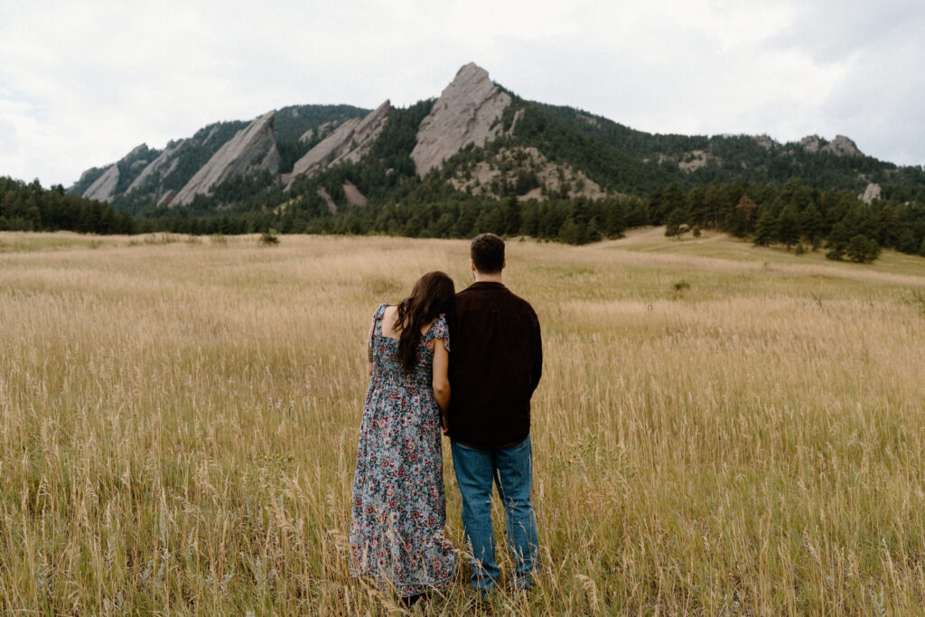 Couple admiring the Flat Irons during an engagement session in Boulder, CO