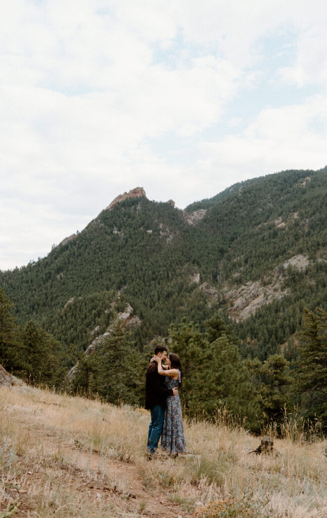 Couple kissing on a hike in Boulder, CO during an engagement session