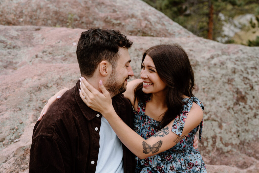 Couple laughing on a hike in Boulder, CO during engagement session
