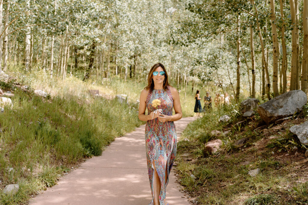 Bridesmaid walking down the aisle during an elopement at Maroon Bells