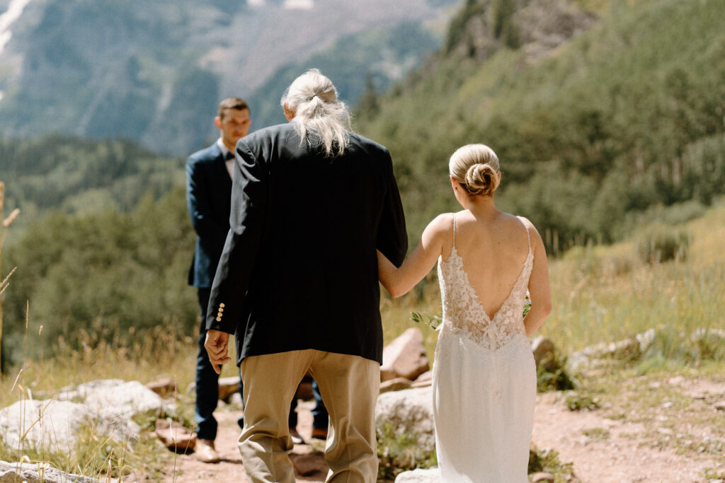 Bride and dad walking up to alter during an elopement at Maroon Bells
