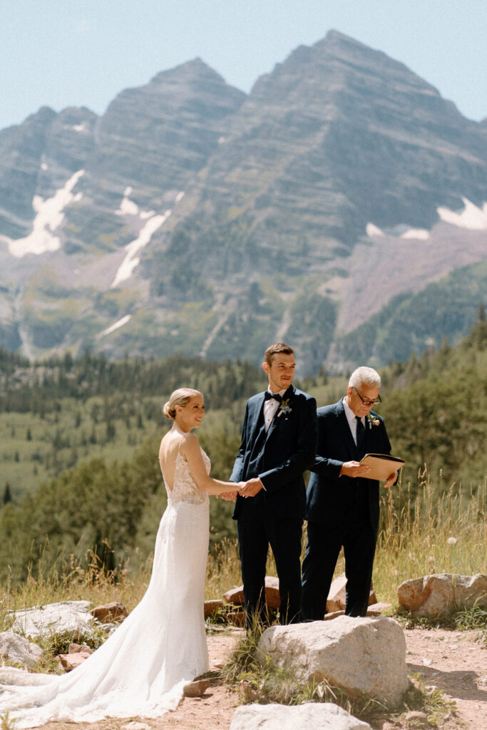 Bride and groom smiling at the alter during an elopement at Maroon Bells