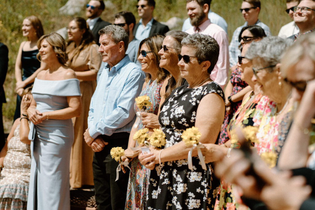 Wedding guests smiling during ceremony during elopement at Maroon Bells