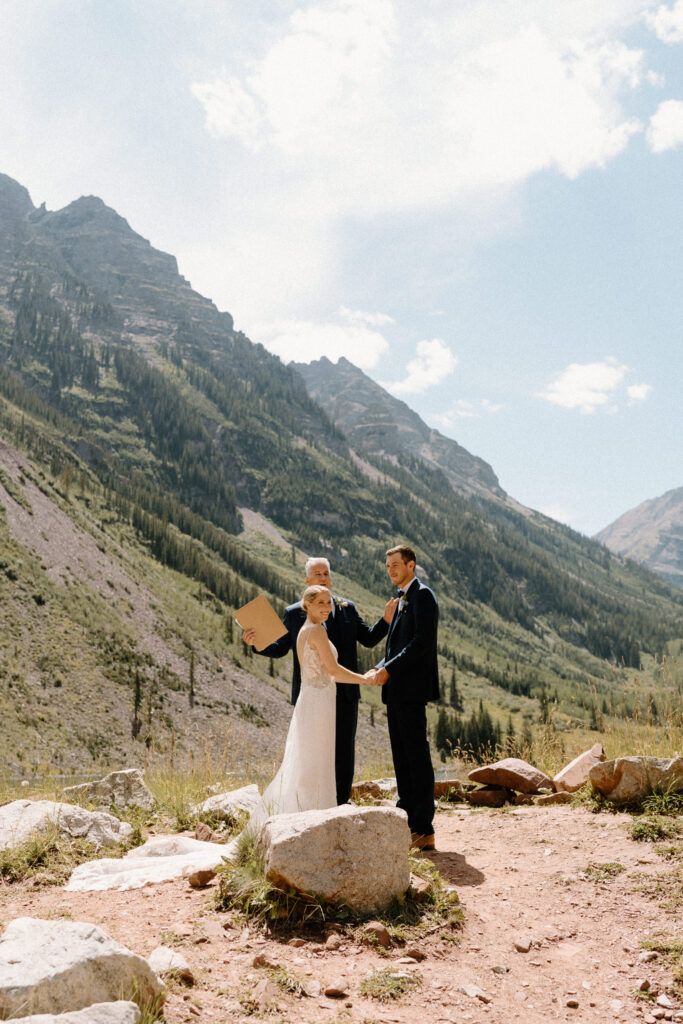 Bride and groom laughing during ceremony during Elopement at Maroon Bells