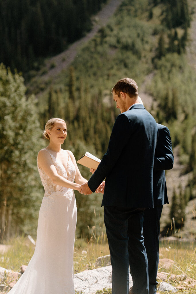 Bride smiling at groom during elopement ceremony at Maroon Bells