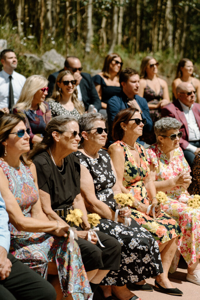 Wedding guests smiling during elopement ceremony at Maroon Bells