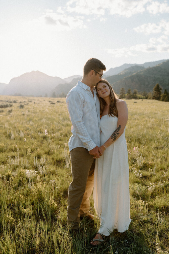 Couple hugging and smiling during an engagement session at Poudre Canyon