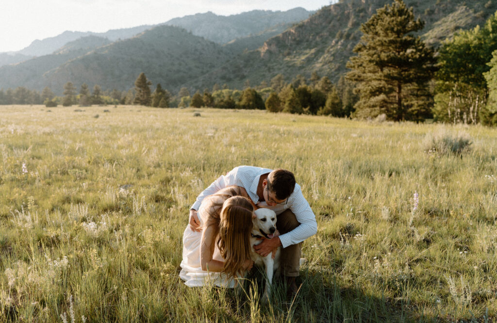Couple hugging dog during engagement session at Poudre Canyon