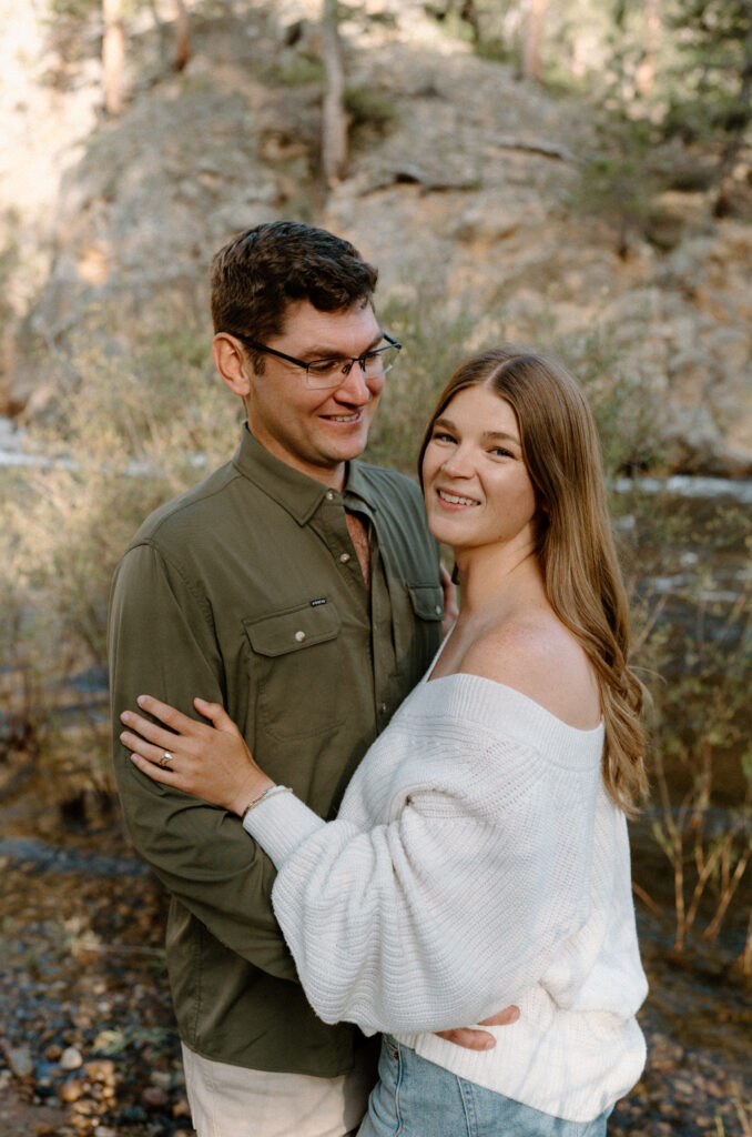 Fiancée smiling at the camera during an engagement session at Poudre Canyon