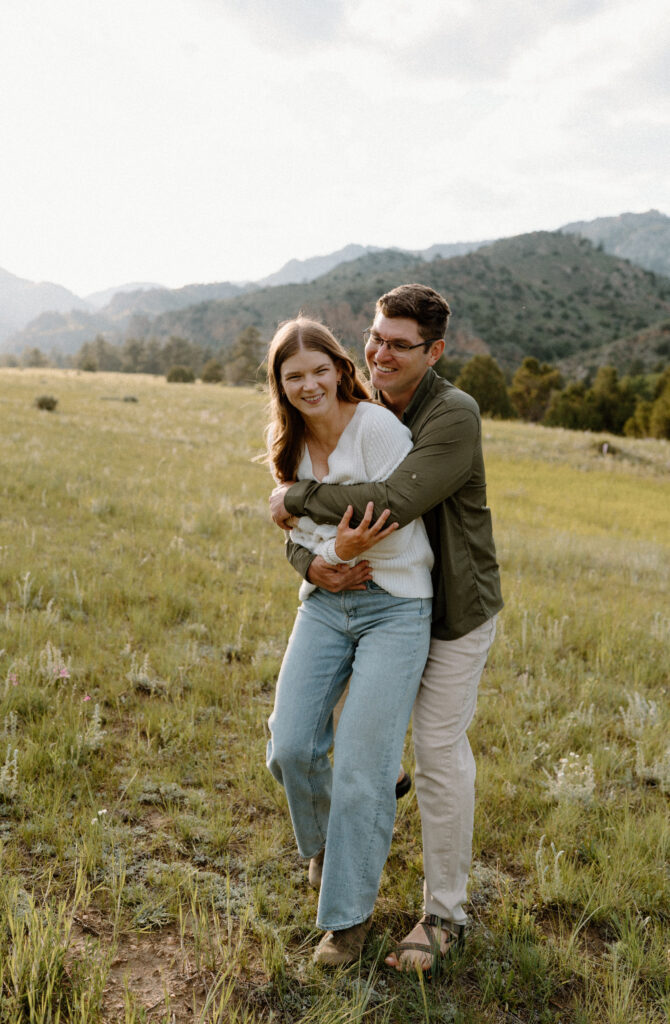 Fiancé holding fiancée during an engagement session at Poudre Canyon
