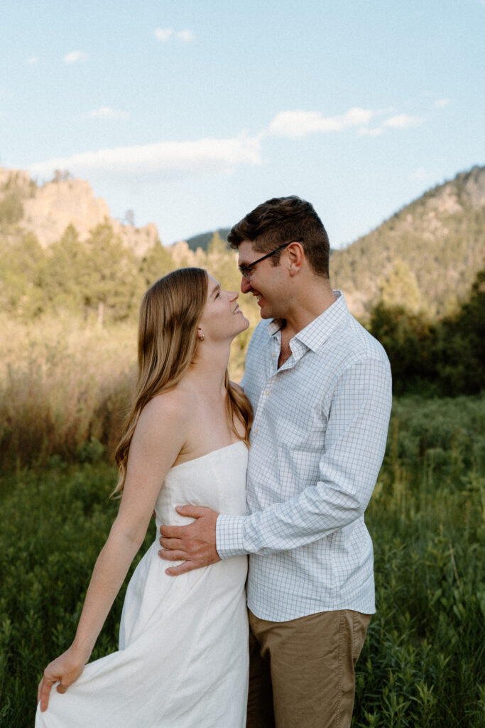 Couple smiling at each other at Poudre Canyon during engagement session