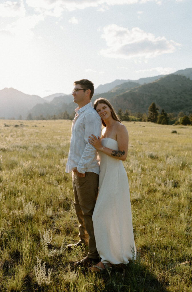 Fiancée hugging fiancé and smiling during engagement session at Poudre Canyon