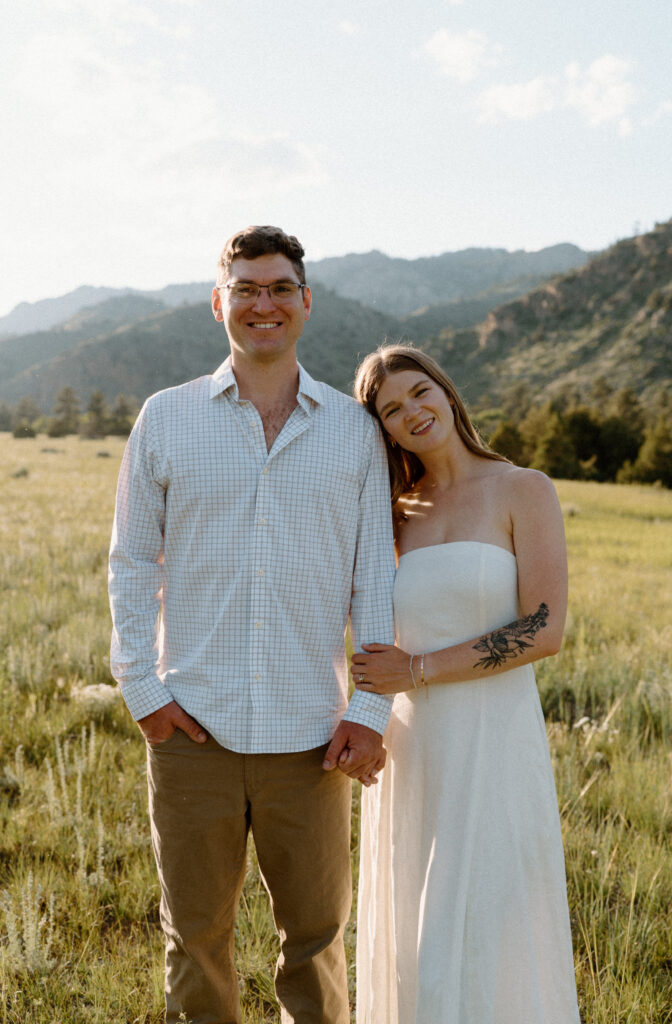 Couple laughing at the camera during engagement session at Poudre Canyon