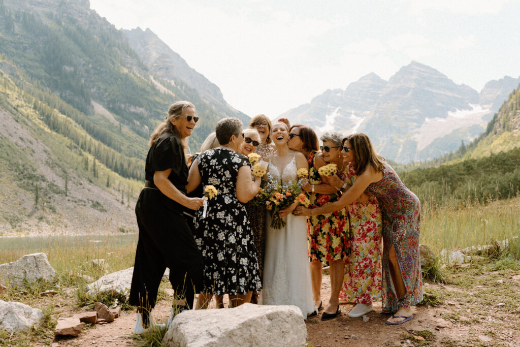 Bride and her family smiling during an elopement at Maroon Bells