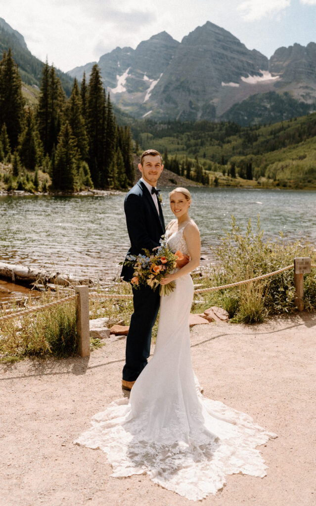 Bride and groom smiling at the camera during an elopement at Maroon Bells