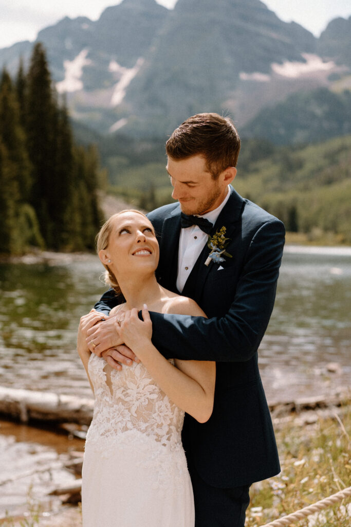 Groom hugging bride and smiling during an elopement at Maroon Bells