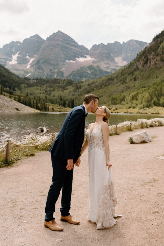 Groom kissing bride during an elopement at Maroon Bells