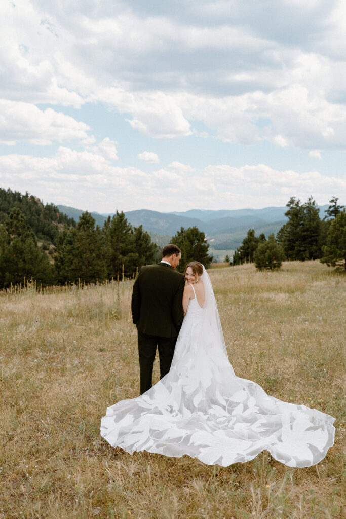 Bride and groom admiring the view of Mt. Falcon on wedding day 