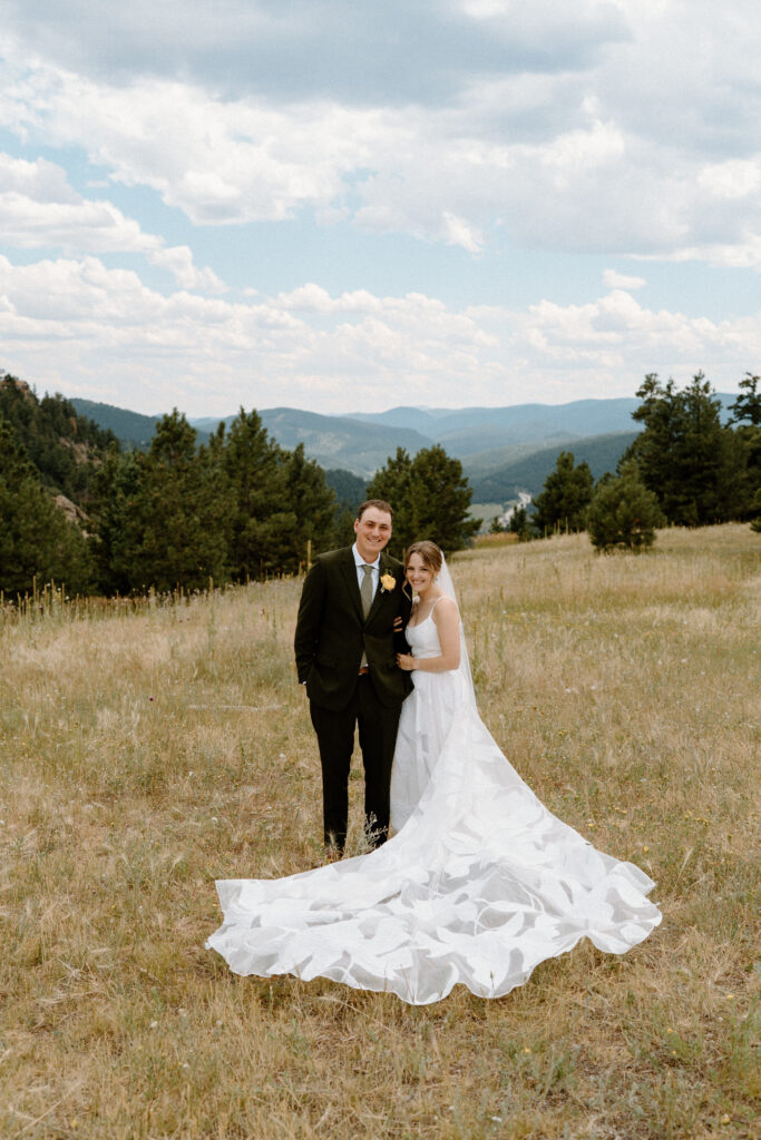 Bride and groom smiling at the camera on wedding day at Mt. Falcon