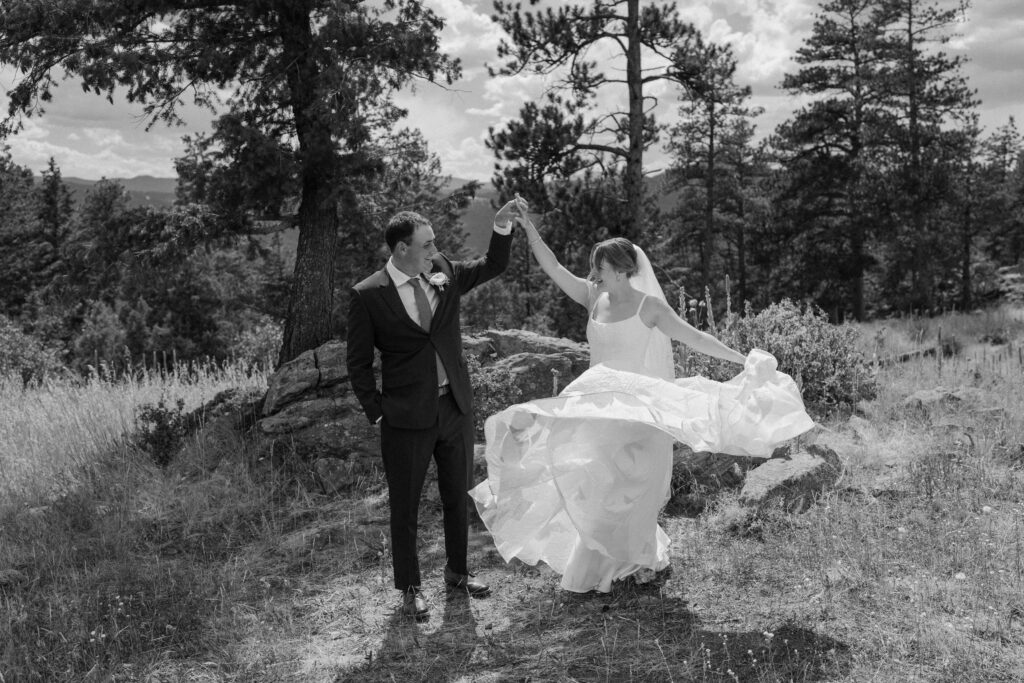 Groom spinning bride on wedding day at Mt. Falcon