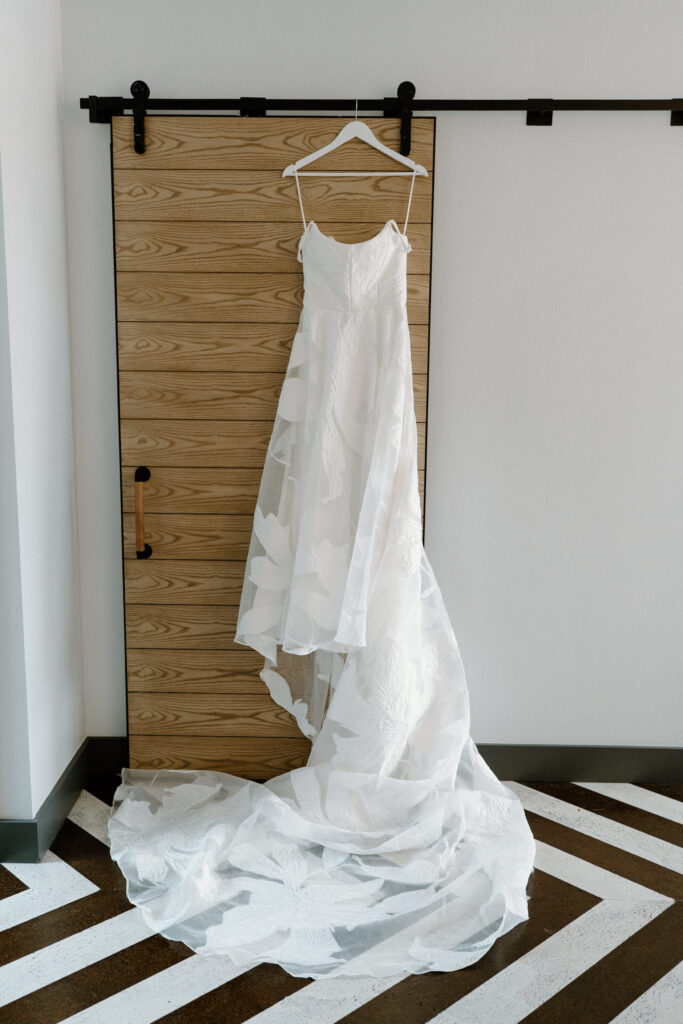 Wedding dress hanging on door on wedding day at Mountain Crust