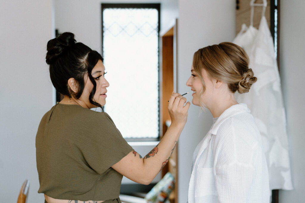 Bride getting make up done at the Maven Hotel in Denver on wedding day