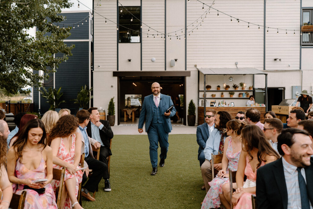 Officiant walking down the aisle on wedding day at Mountain Crust