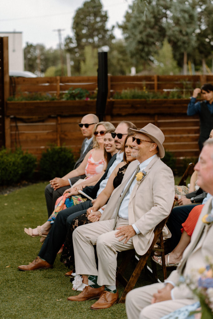 Couple's parents smiling during wedding ceremony at Mountain Crust