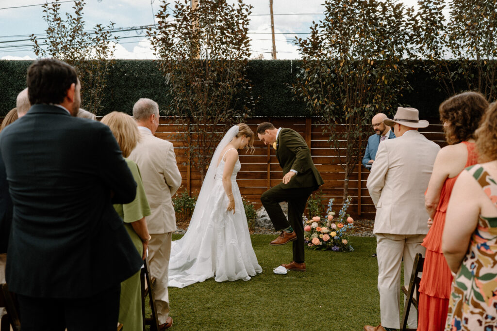 Groom smashing a plate during wedding ceremony at Mountain Crust 