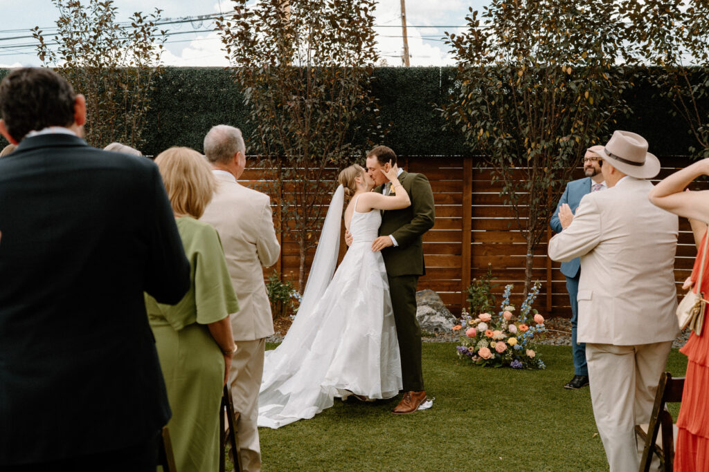 Bride and groom kissing during wedding ceremony at Mountain Crust