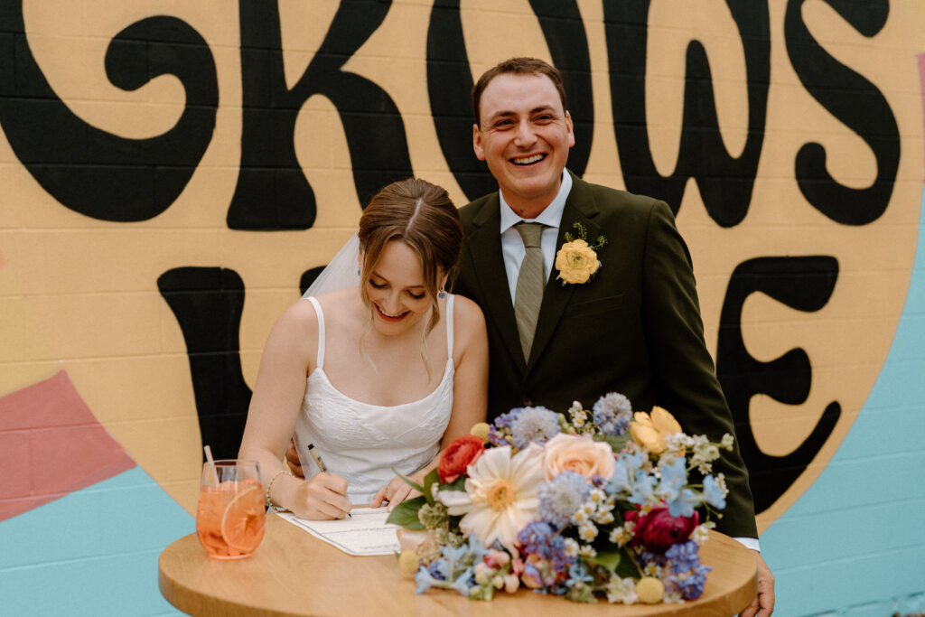 Bride signing marriage license on wedding day at Mountain Crust