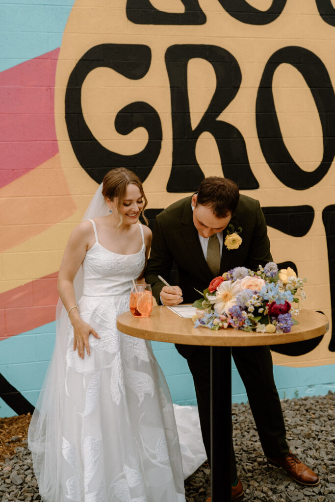Groom signing marriage license on wedding day at Mountain Crust