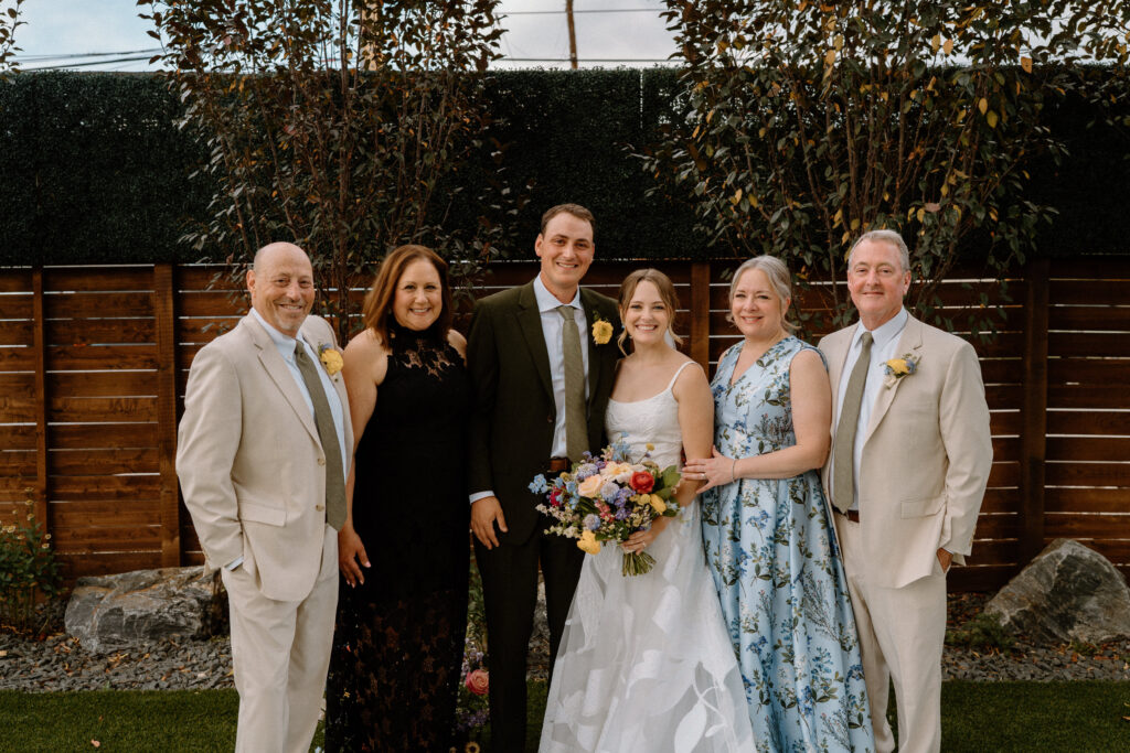 Bride and groom with parents on wedding day at Mountain Crust