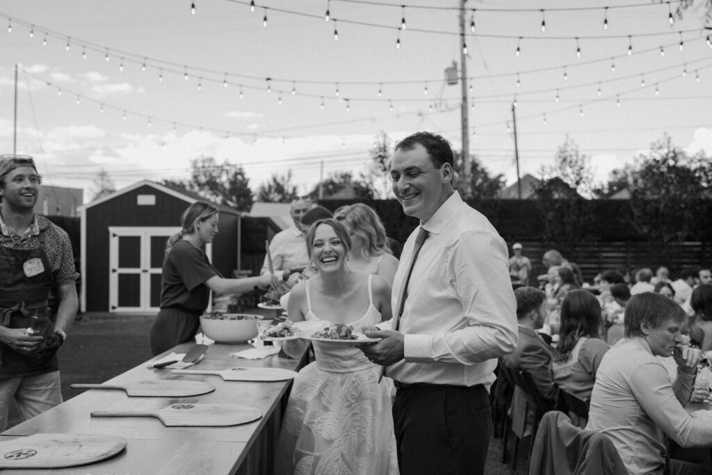 Bride and groom getting pizza at Mountain Crust on wedding day 