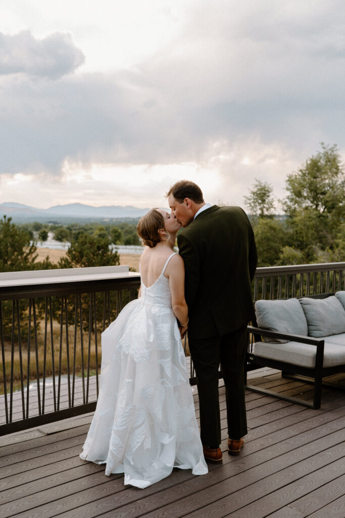 Bride and groom kissing on the patio at Mountain Crust on wedding day 
