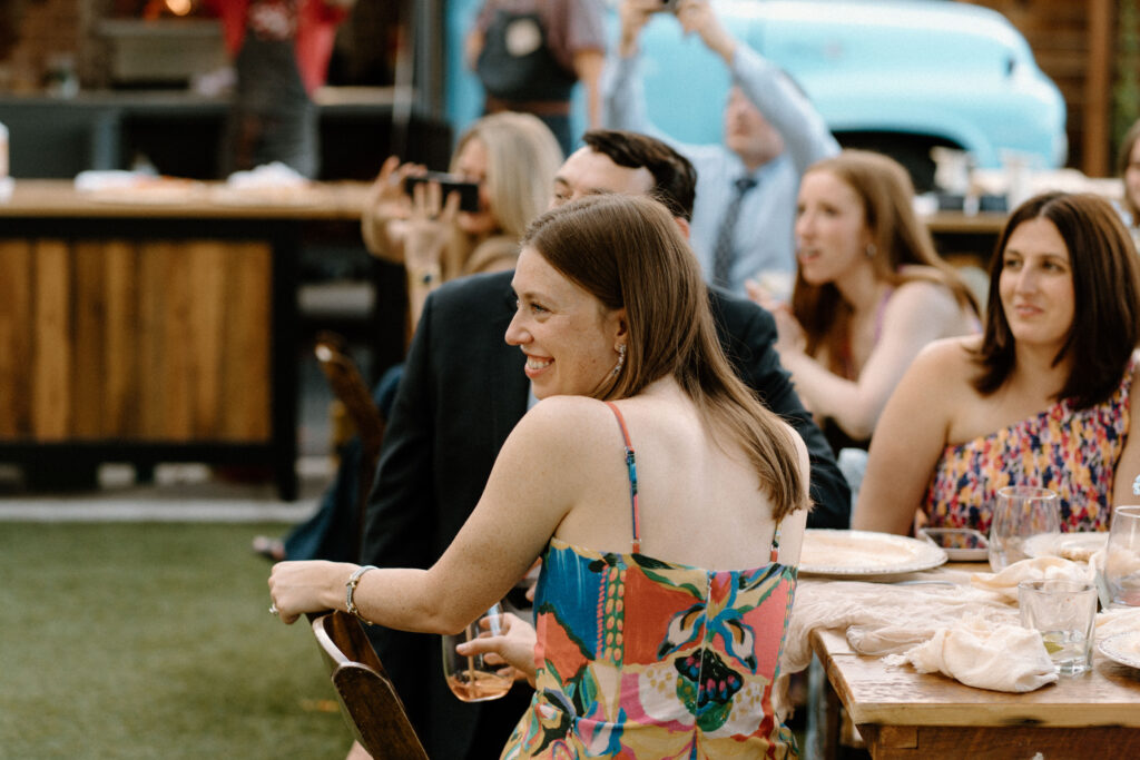Wedding guests smiling during speeches on wedding day at Mountain Crust 