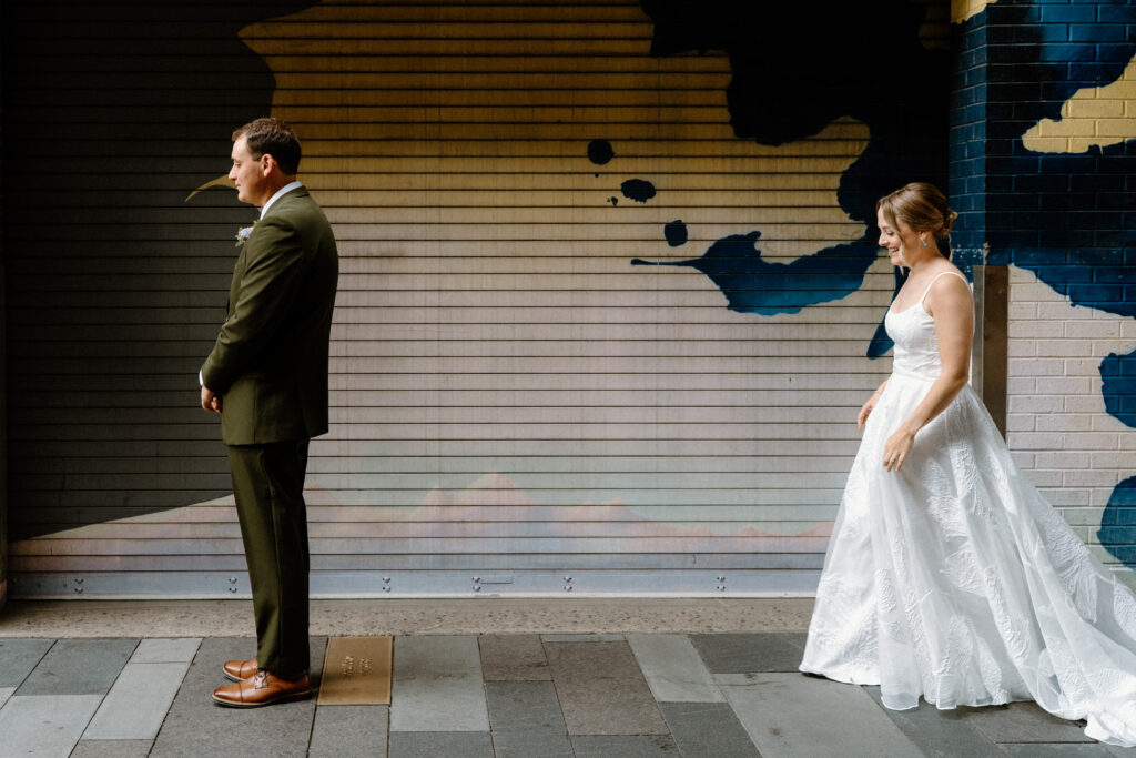 Bride walking to groom during first look on wedding day