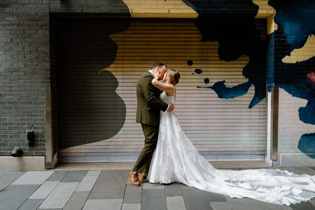 Bride and groom kissing during first look on wedding day in Denver