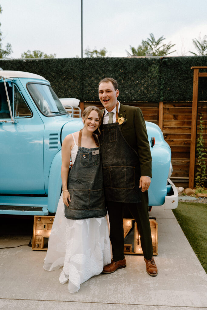 Bride and groom smiling in front of pizza truck at Mountain Crust