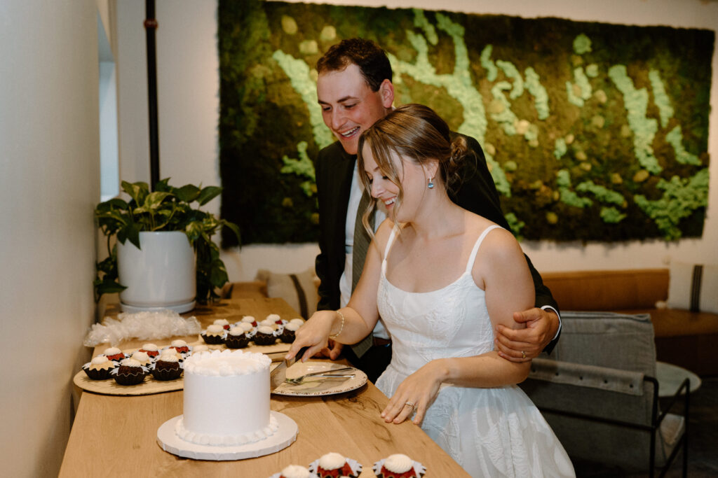 Bride and groom cutting cake on wedding day at Mountain Crust