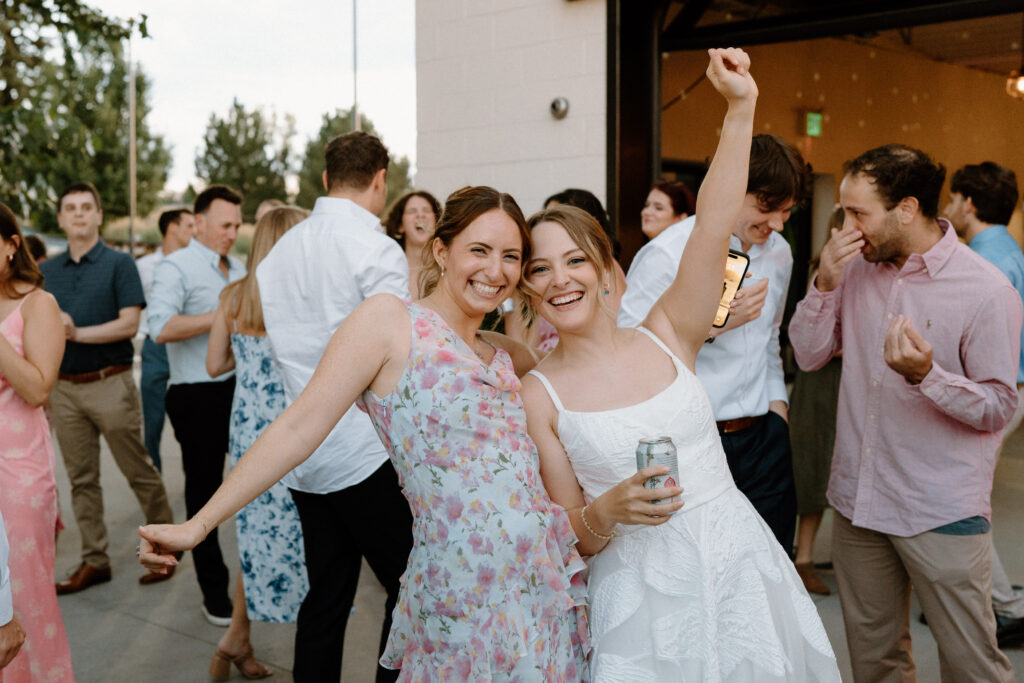 Bride smiling with wedding guest on wedding day at Mountain Crust