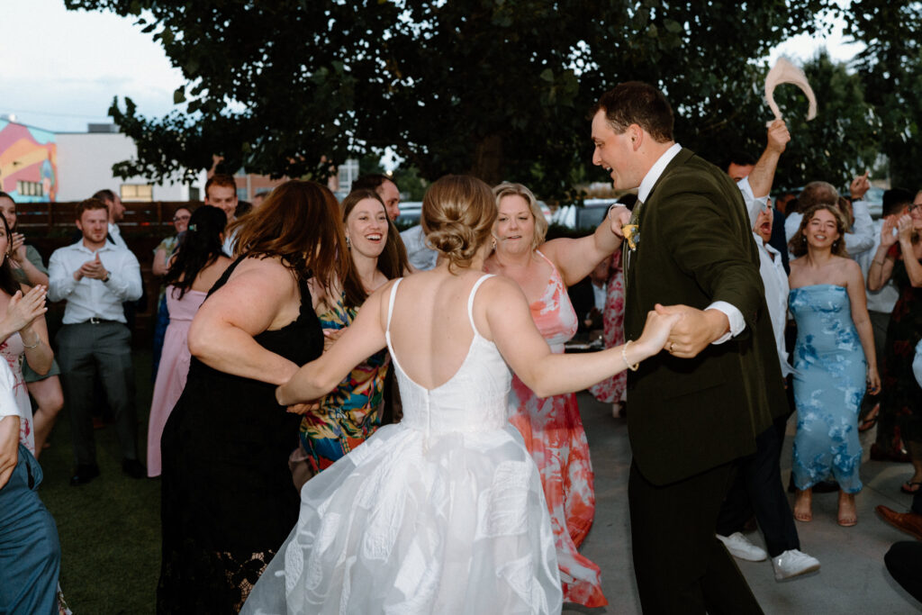 Bride and groom dancing with wedding guests at Mountain Crust 