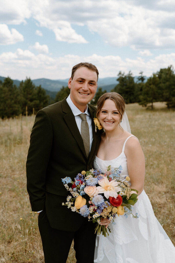Bride and groom smiling on wedding day at Mt. Falcon