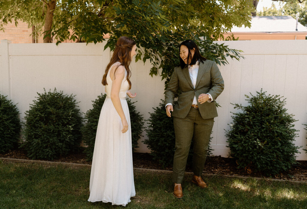 Bride's laughing during first look on wedding day at Sunrise Amphitheater 