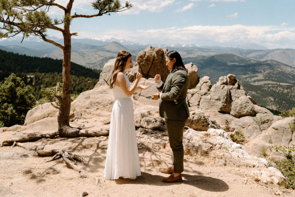 Couple playing rock paper scissors on wedding day at Sunrise Amphitheater 